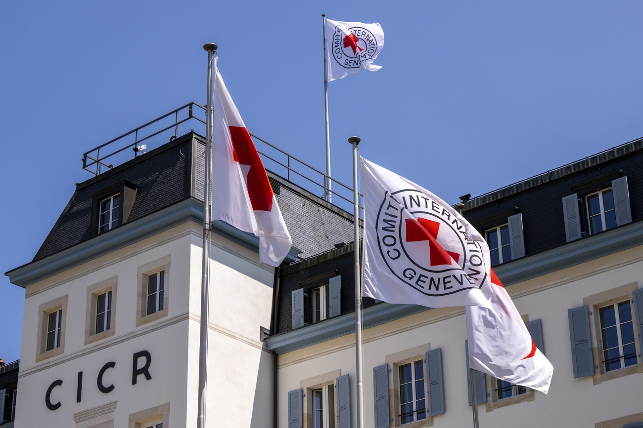white building with flags in front of it
