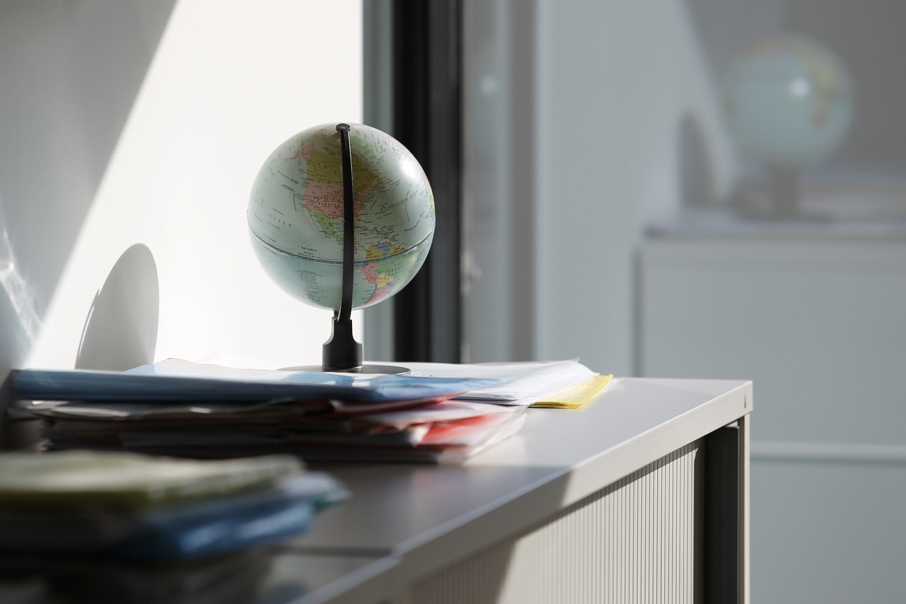 Files next to a globe on a desk in an office of the Swiss Federal Statistical Office in Neuchatel in the canton of Neuchatel, Switzerland, pictured on November 6, 2010.